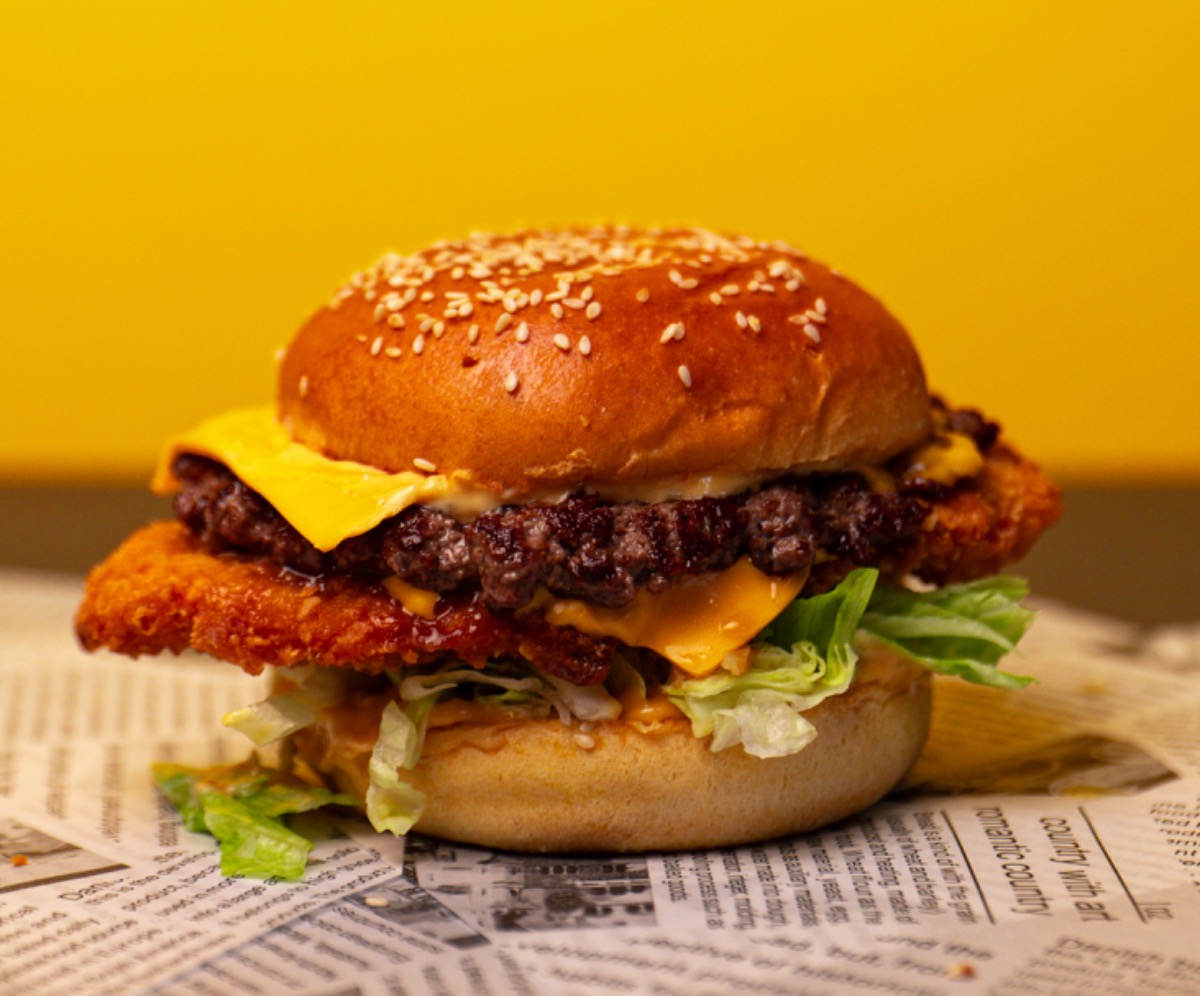 Chicken burger in a bun with slaw and pickles